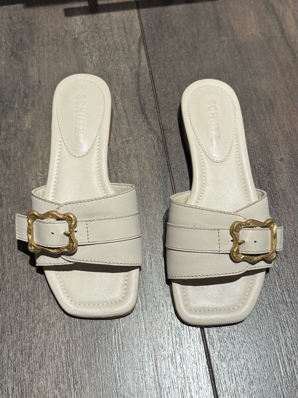 SCHUTZ Cream Slide Sandals with Gold Buckle Accent
